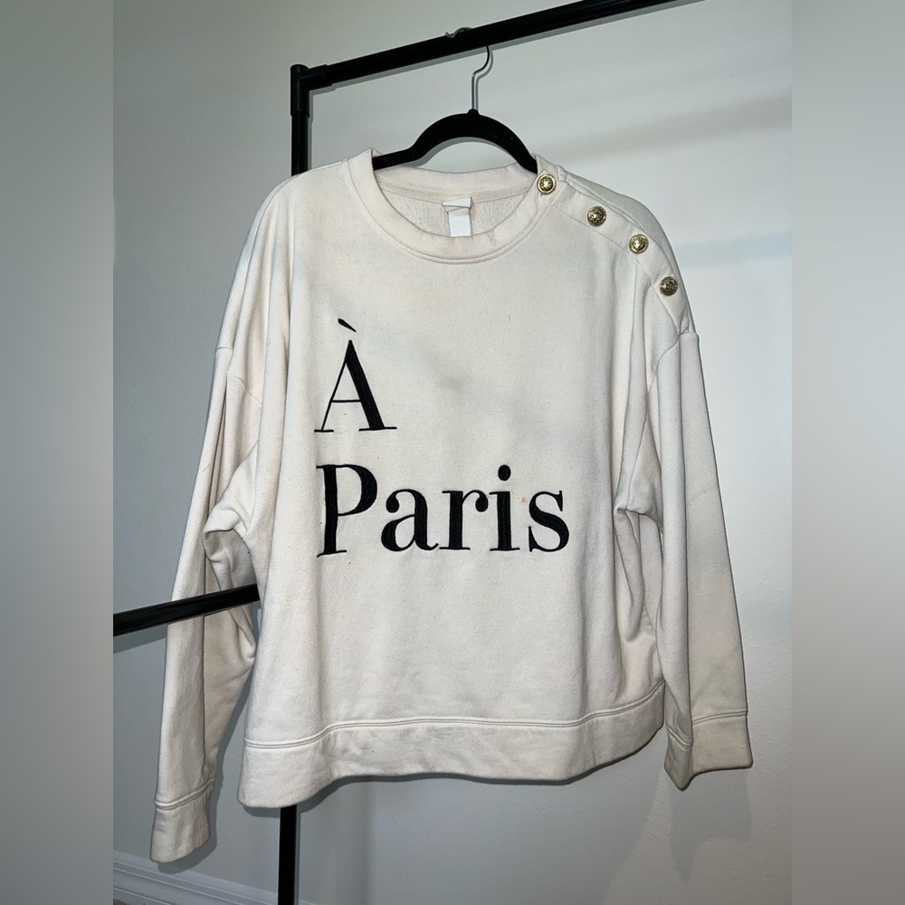 À Paris white crew neck sweater with one sided gold buttons on shoulders